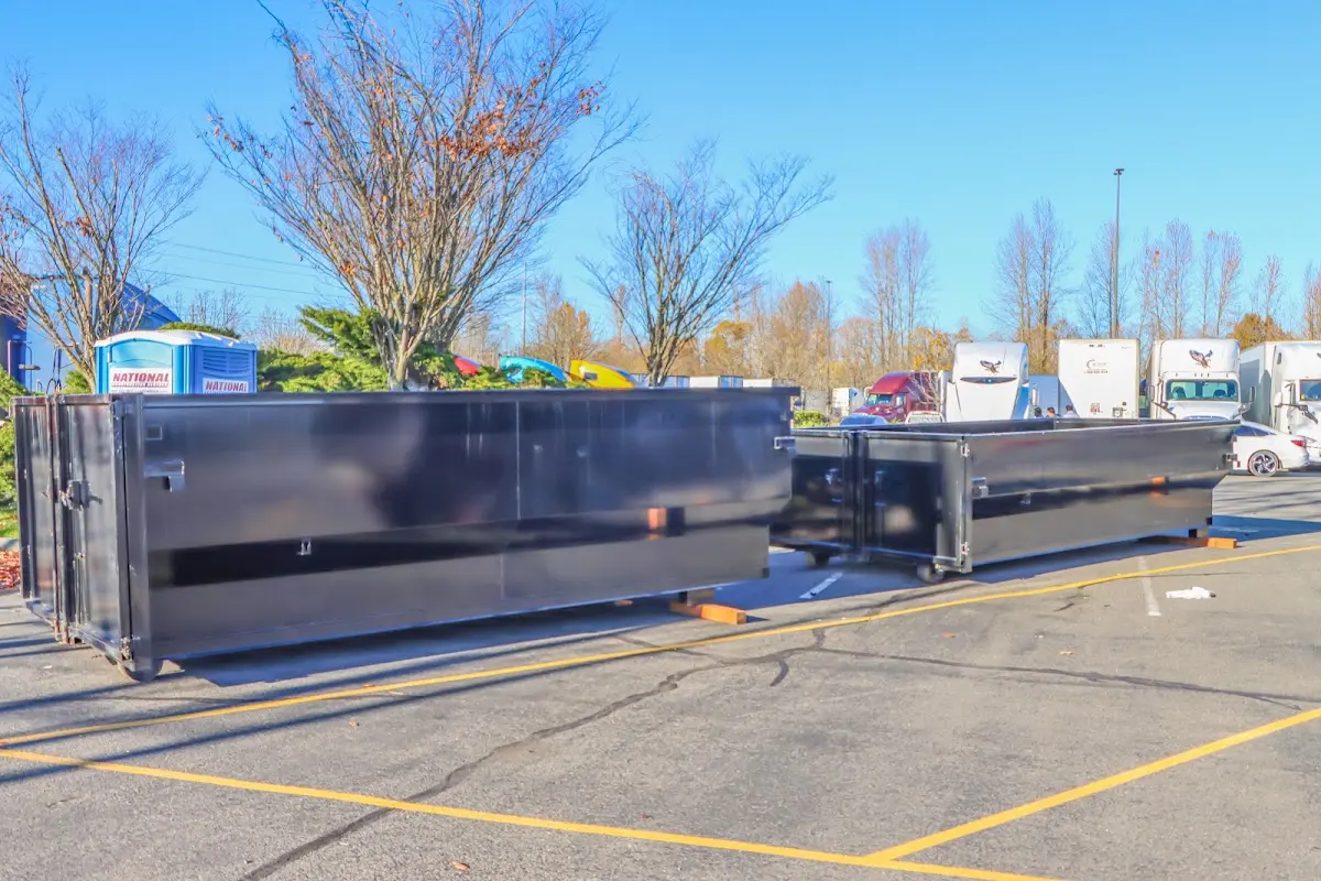 Professional dumpster rental service with roll-off container on residential driveway in Ellsworth